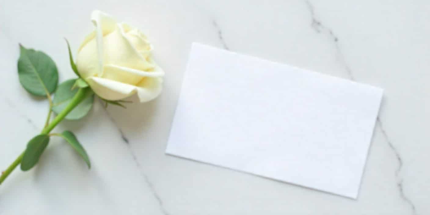 Sympathy card with white rose expressing condolences for friend’s father’s death.