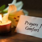 Comforting candle-and-flowers setup with a sympathy prayer message.