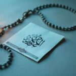 prayer setup with Arabic calligraphy, misbaha beads, and a glowing lantern for a daughter-in-law prayer.
